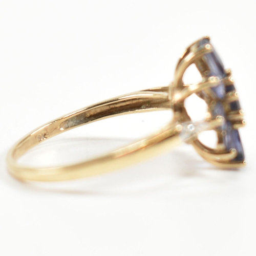 354 - A hallmarked 9ct gold and iolite cluster ring. The ring having a central eight claw set round cut io... 