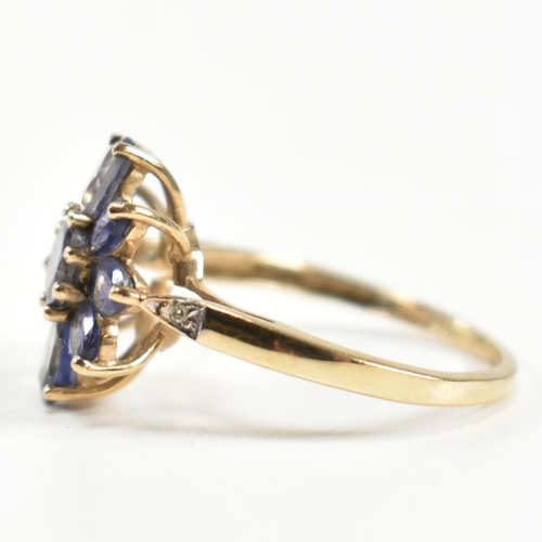 354 - A hallmarked 9ct gold and iolite cluster ring. The ring having a central eight claw set round cut io... 