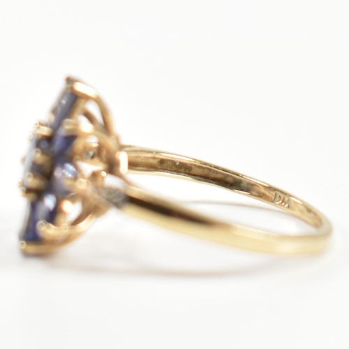 354 - A hallmarked 9ct gold and iolite cluster ring. The ring having a central eight claw set round cut io... 