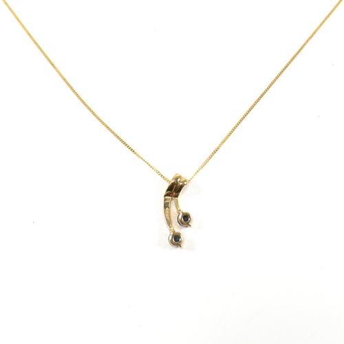 361 - A hallmarked 9ct gold and sapphire pendant necklace. The 9ct gold fine curb link chain necklace stru... 