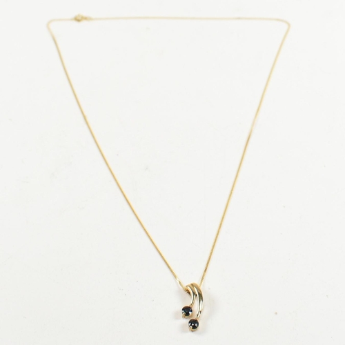 361 - A hallmarked 9ct gold and sapphire pendant necklace. The 9ct gold fine curb link chain necklace stru... 