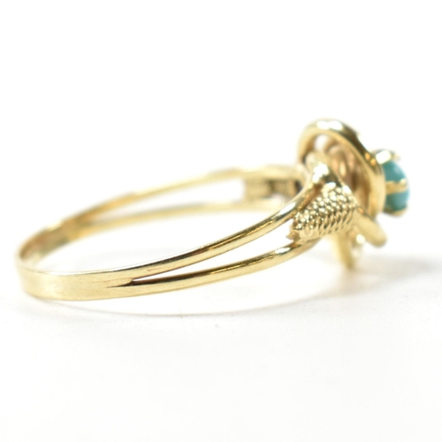 378 - A 14ct gold and blue stone ring. The 14ct gold ring having a central twist design set with a round b... 