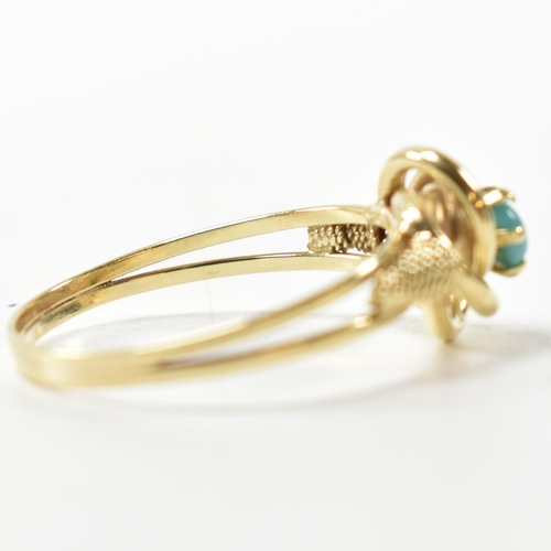 378 - A 14ct gold and blue stone ring. The 14ct gold ring having a central twist design set with a round b... 