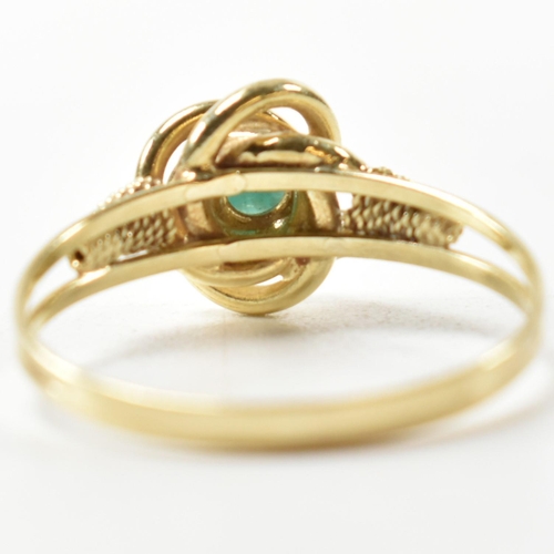 378 - A 14ct gold and blue stone ring. The 14ct gold ring having a central twist design set with a round b... 