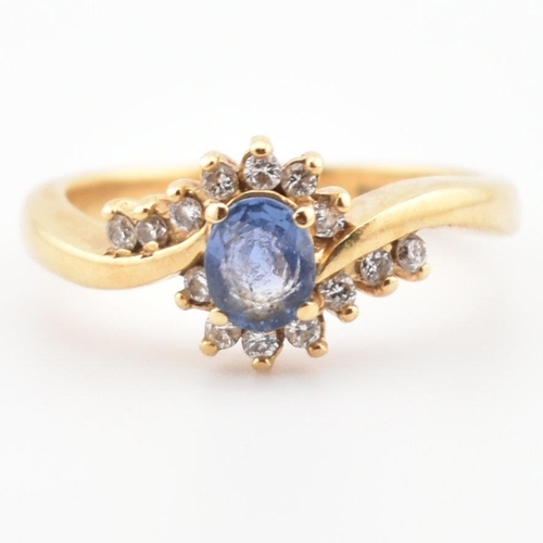 39 - A hallmarked 18ct gold, Ceylon sapphire and diamond ring. The ring having a central oval cut Ceylon ... 