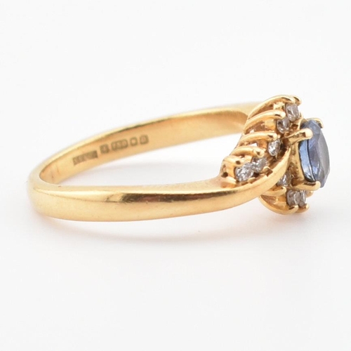 39 - A hallmarked 18ct gold, Ceylon sapphire and diamond ring. The ring having a central oval cut Ceylon ... 