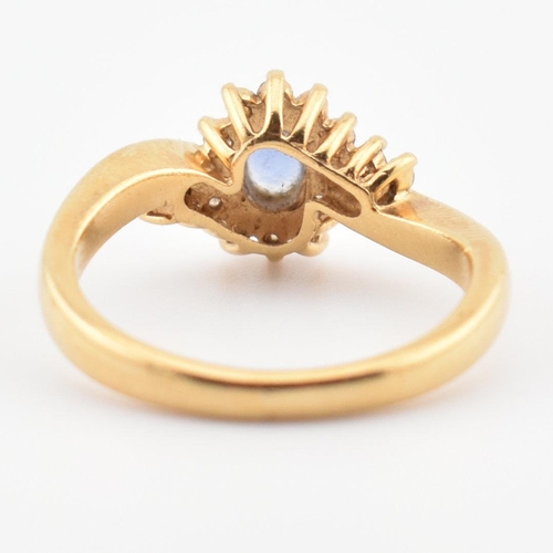 39 - A hallmarked 18ct gold, Ceylon sapphire and diamond ring. The ring having a central oval cut Ceylon ... 