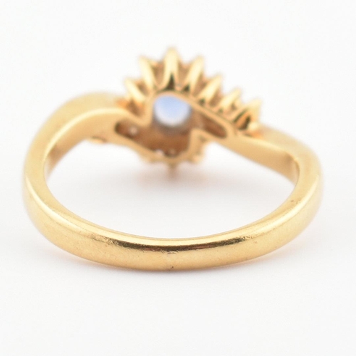 39 - A hallmarked 18ct gold, Ceylon sapphire and diamond ring. The ring having a central oval cut Ceylon ... 