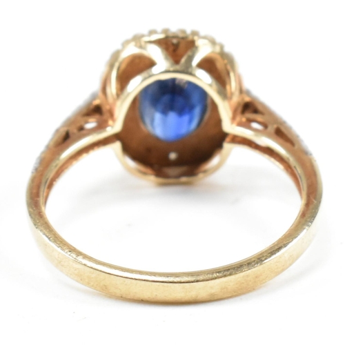 393 - A hallmarked 9ct gold, sapphire and diamond ring. The ring having an oval cut sapphire set in a whit... 