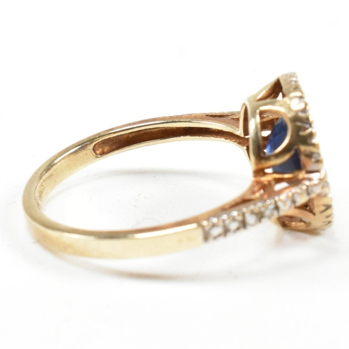 393 - A hallmarked 9ct gold, sapphire and diamond ring. The ring having an oval cut sapphire set in a whit... 