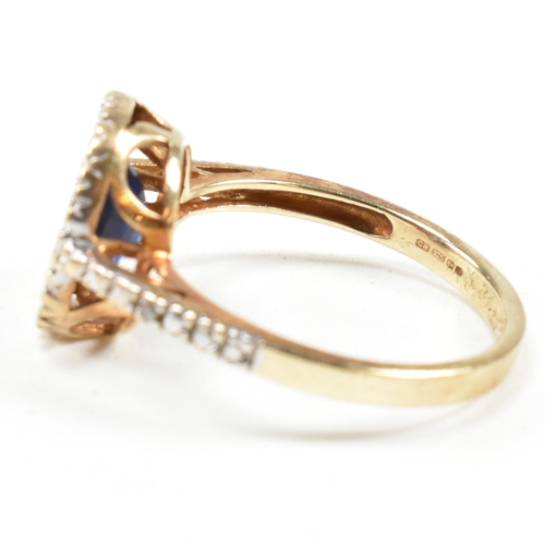 393 - A hallmarked 9ct gold, sapphire and diamond ring. The ring having an oval cut sapphire set in a whit... 