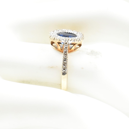 393 - A hallmarked 9ct gold, sapphire and diamond ring. The ring having an oval cut sapphire set in a whit... 