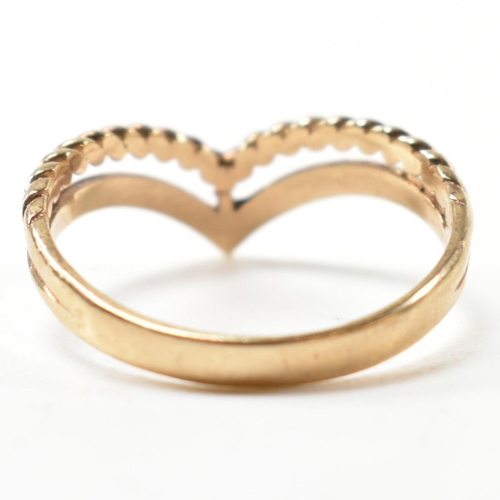 397 - A hallmarked 9ct gold two strand wishbone ring. The pierced 9ct gold wishbone ring having a twisted ... 