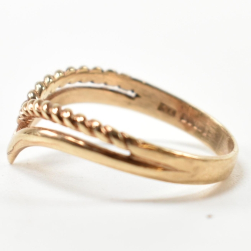 397 - A hallmarked 9ct gold two strand wishbone ring. The pierced 9ct gold wishbone ring having a twisted ... 