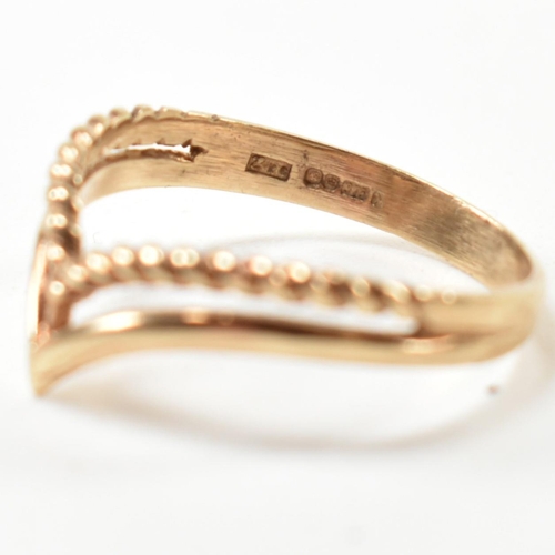 397 - A hallmarked 9ct gold two strand wishbone ring. The pierced 9ct gold wishbone ring having a twisted ... 