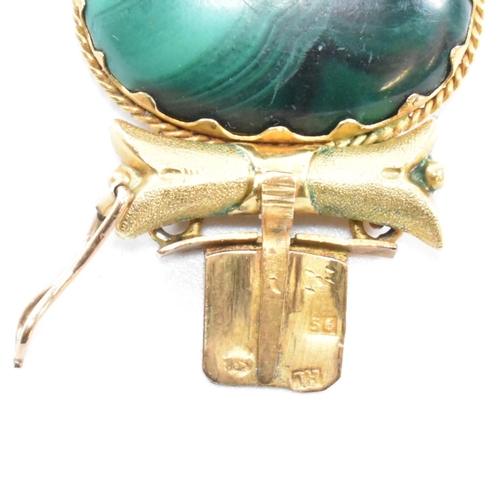 4 - A 19th century gold and malachite panel bracelet. The bracelet mounted with seven oval malachite pan... 