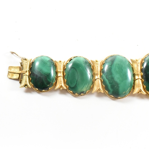 4 - A 19th century gold and malachite panel bracelet. The bracelet mounted with seven oval malachite pan... 