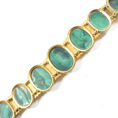 4 - A 19th century gold and malachite panel bracelet. The bracelet mounted with seven oval malachite pan... 