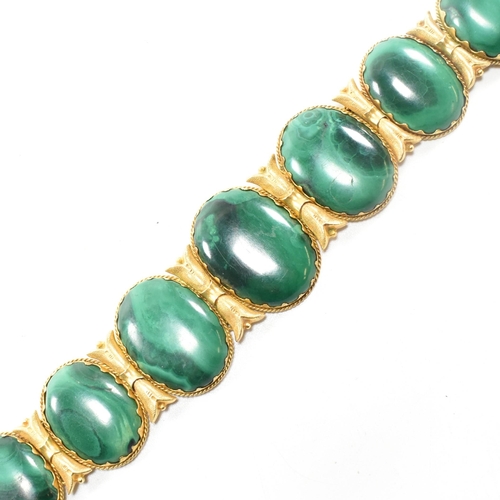 4 - A 19th century gold and malachite panel bracelet. The bracelet mounted with seven oval malachite pan... 