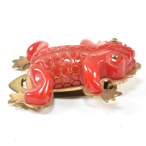 42 - A 1930s Bakelite red frog dress clip. The dress clip having a red Bakelite frog on a gold tone metal... 