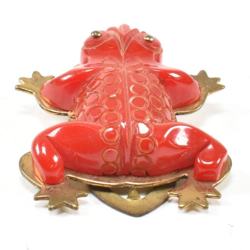 42 - A 1930s Bakelite red frog dress clip. The dress clip having a red Bakelite frog on a gold tone metal... 