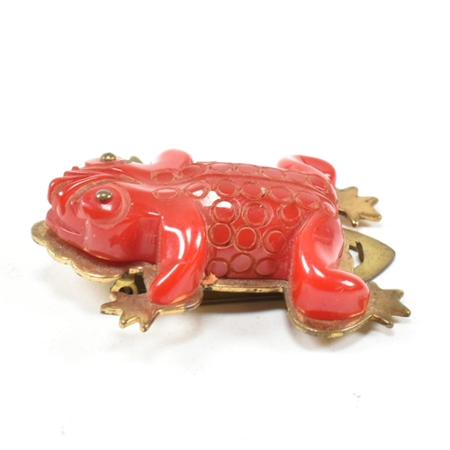 42 - A 1930s Bakelite red frog dress clip. The dress clip having a red Bakelite frog on a gold tone metal... 