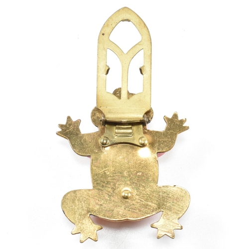 42 - A 1930s Bakelite red frog dress clip. The dress clip having a red Bakelite frog on a gold tone metal... 