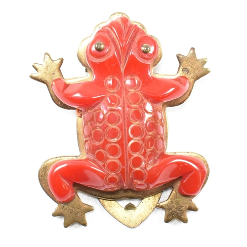 42 - A 1930s Bakelite red frog dress clip. The dress clip having a red Bakelite frog on a gold tone metal... 