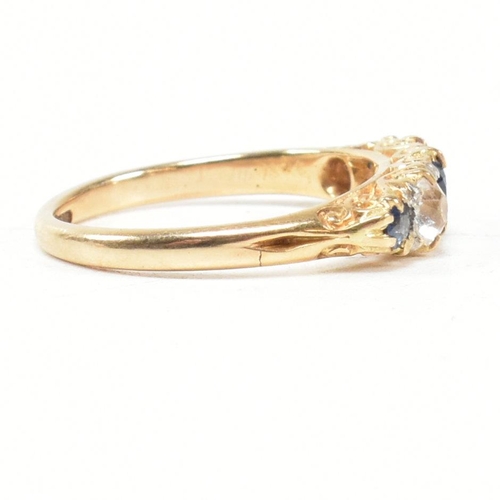 49 - An 18ct gold and sapphire five stone gypsy ring. The ring set with blue and white sapphire to a scro... 