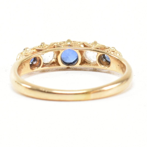 49 - An 18ct gold and sapphire five stone gypsy ring. The ring set with blue and white sapphire to a scro... 