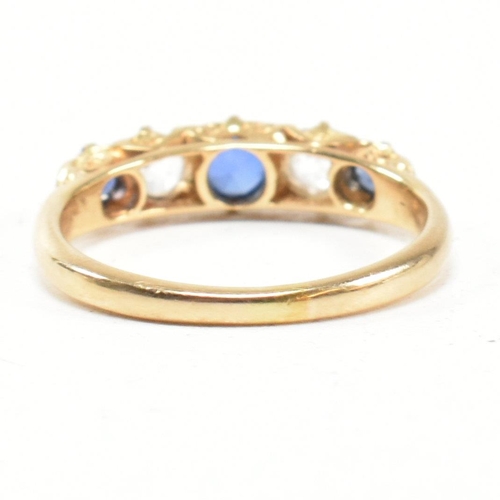 49 - An 18ct gold and sapphire five stone gypsy ring. The ring set with blue and white sapphire to a scro... 