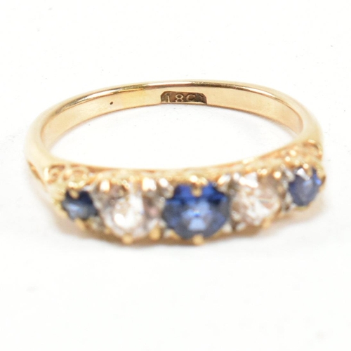 49 - An 18ct gold and sapphire five stone gypsy ring. The ring set with blue and white sapphire to a scro... 