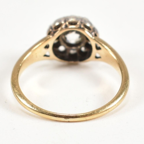 51 - A gold and diamond cluster ring. The ring having a central old cut diamond surrounded by a halo of t... 