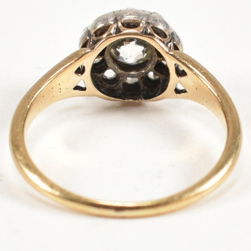 51 - A gold and diamond cluster ring. The ring having a central old cut diamond surrounded by a halo of t... 