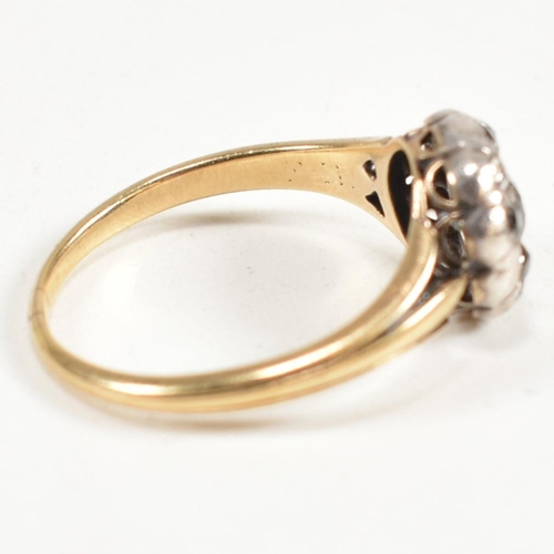 51 - A gold and diamond cluster ring. The ring having a central old cut diamond surrounded by a halo of t... 