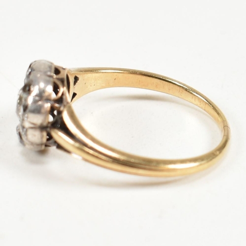 51 - A gold and diamond cluster ring. The ring having a central old cut diamond surrounded by a halo of t... 