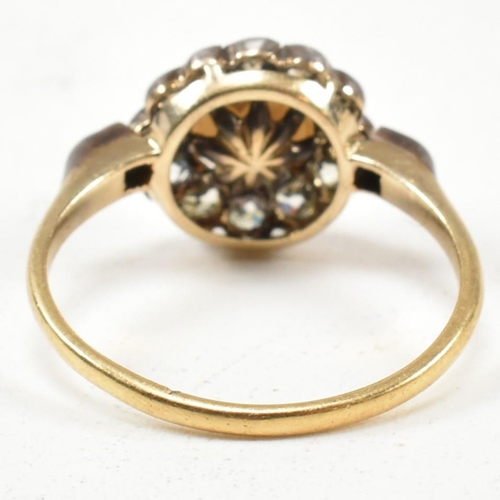 53 - An early 20th century pearl and diamond cluster ring. The ring set with a central half pearl framed ... 