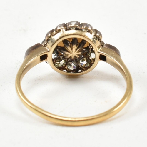 53 - An early 20th century pearl and diamond cluster ring. The ring set with a central half pearl framed ... 