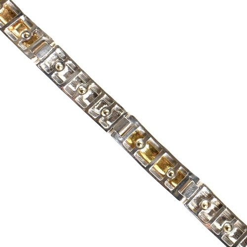 55 - An Italian 18ct gold screw detail link bracelet. The bracelet having two-tone yellow and white 18ct ... 