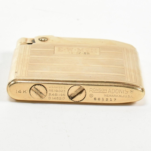 56 - A gold Ronson Adonis pocket lighter stamped 14k. The 14ct gold pocket lighter having an all-over eng... 