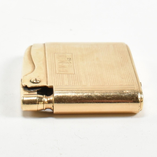 56 - A gold Ronson Adonis pocket lighter stamped 14k. The 14ct gold pocket lighter having an all-over eng... 