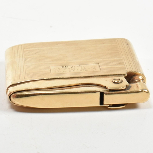 56 - A gold Ronson Adonis pocket lighter stamped 14k. The 14ct gold pocket lighter having an all-over eng... 