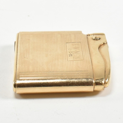 56 - A gold Ronson Adonis pocket lighter stamped 14k. The 14ct gold pocket lighter having an all-over eng... 