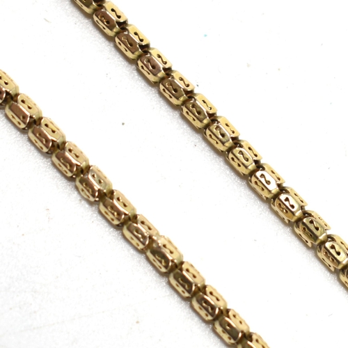 59 - A 9ct gold fancy link chain necklace. The necklace having fancy pierced barrel shaped links to barre... 