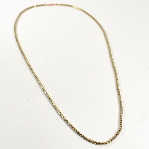 59 - A 9ct gold fancy link chain necklace. The necklace having fancy pierced barrel shaped links to barre... 