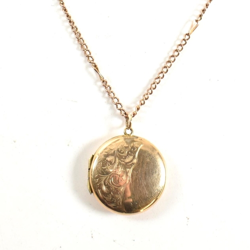 60 - A 9ct gold locket pendant necklace. The 9ct gold round engraved locket strung on a curb link chain n... 