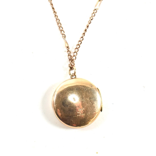 60 - A 9ct gold locket pendant necklace. The 9ct gold round engraved locket strung on a curb link chain n... 