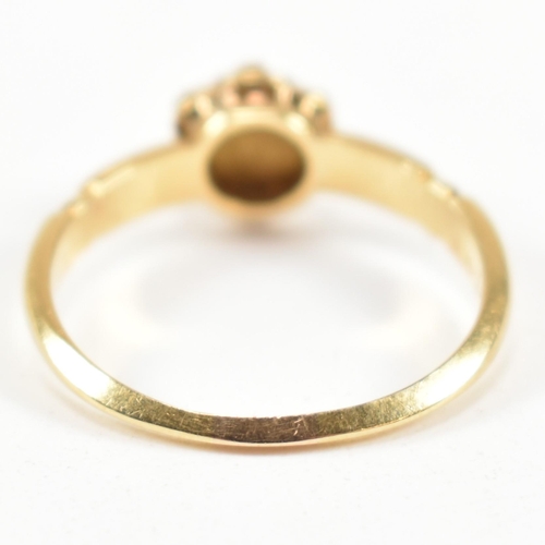 63 - A Victorian hallmarked 18ct gold and seed pearl cluster ring. The ring having a cluster of seven rou... 