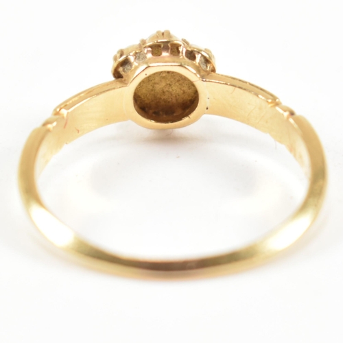 63 - A Victorian hallmarked 18ct gold and seed pearl cluster ring. The ring having a cluster of seven rou... 