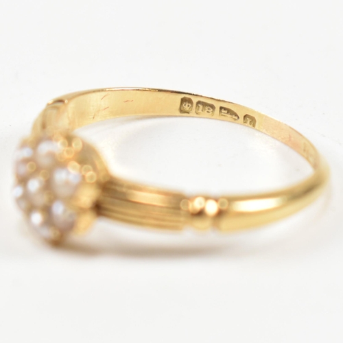 63 - A Victorian hallmarked 18ct gold and seed pearl cluster ring. The ring having a cluster of seven rou... 